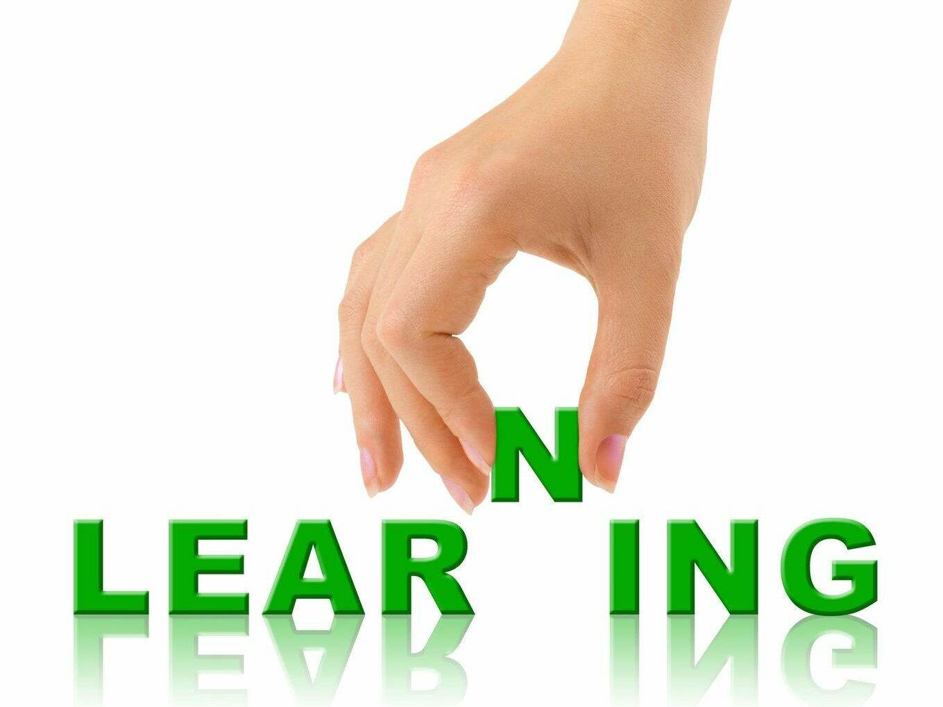 A hand places the letter 'N' between the green letters 'LEAR' and 'ING' to complete the word 'LEARNING.' Symbolizing the process of lifelong learning and continuous development.