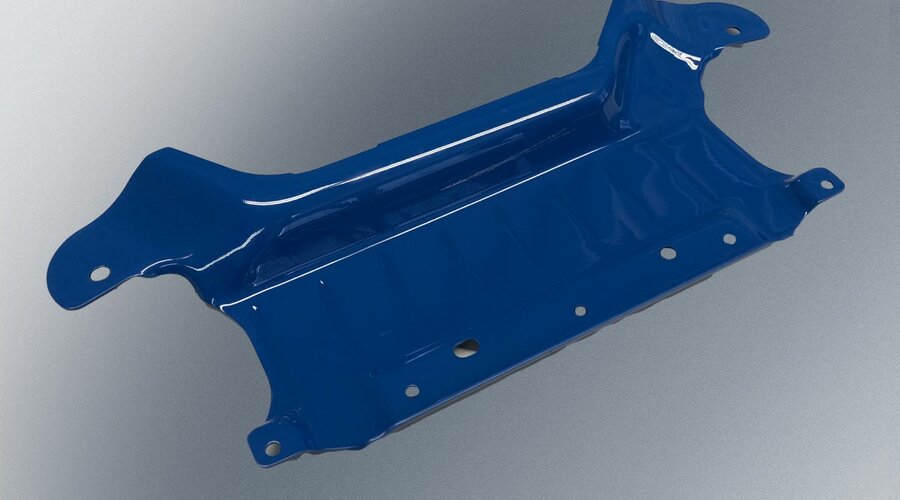 A blue-coated underbody protection component from the automotive sector, designed for maximum safety and stability.